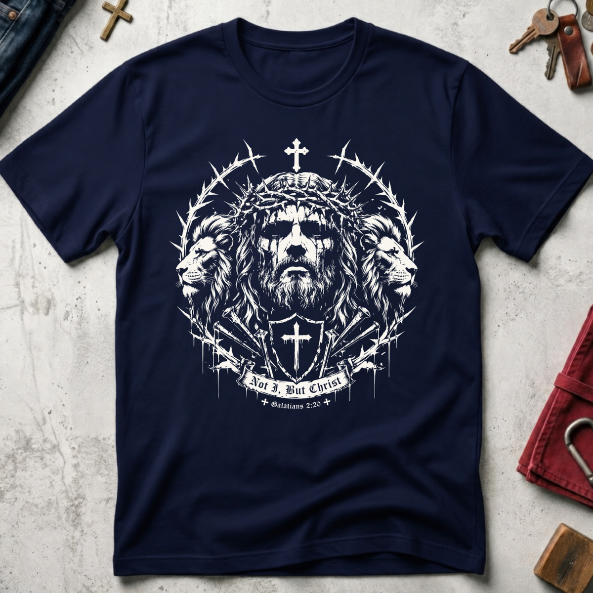 Navy Christian T-shirt with gothic Jesus and lion artwork, a cross shield and the words "Not I, But Christ" from Galatians 2:20.